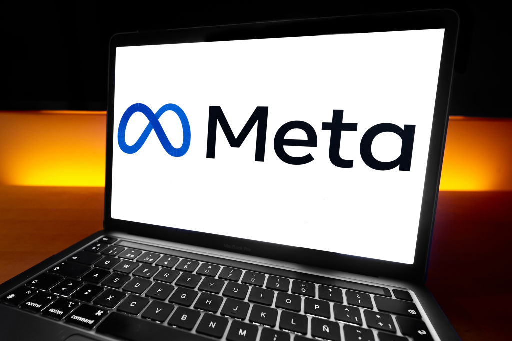 The Meta Platforms logo (formerly Facebook), the American multinational technology conglomerate founded by Mark Zuckerberg that owns and operates some of the world's most used social media platforms like Facebook, Instagram, or WhatsApp, appears on a MacBook in Barcelona, Spain, on February 10, 2025. (Photo by Joan Cros/NurPhoto via Getty Images)