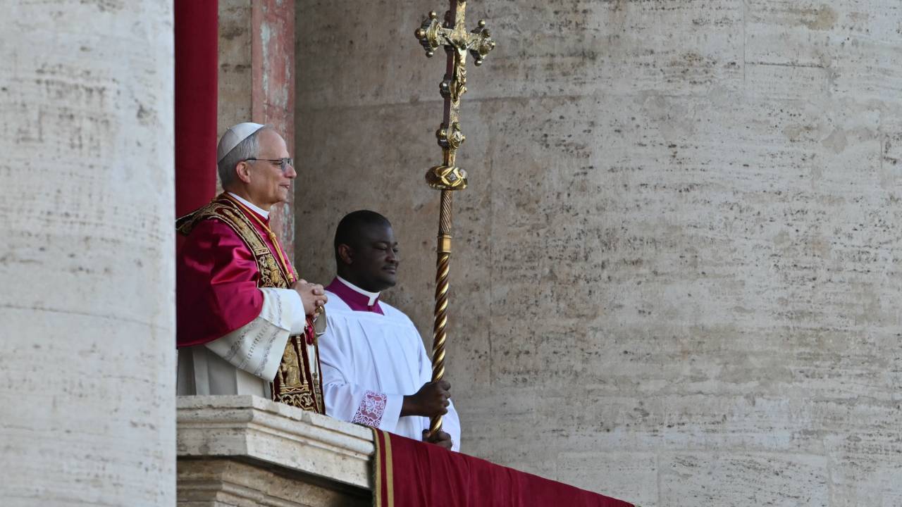 Newly elected Pope Robert Francis Prevost arrives on the main central loggia balcony of the St Peter's Basilica for the first time, after the cardinals ended the conclave, in The Vatican, on May 8, 2025. Robert Francis Prevost was on Thursday elected the first pope from the United States, the Vatican announced. A moderate who was close to Pope Francis and spent years as a missionary in Peru, he becomes the Catholic Church's 267th pontiff, taking the papal name Leo XIV. (Photo by Andrej ISAKOVIC / AFP)