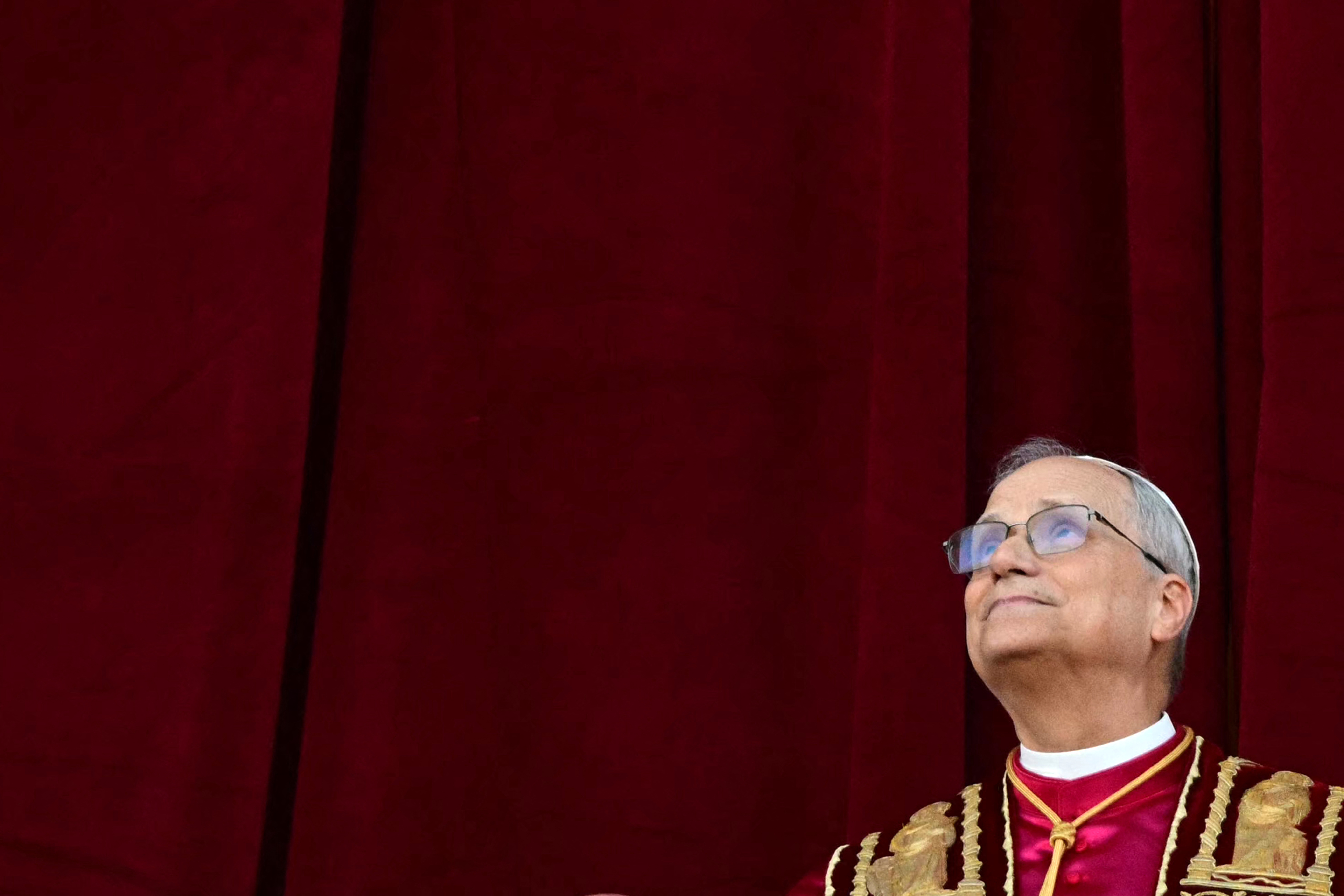 Newly elected Pope Leo XIV, Robert Prevost addresses the crowd from the main central loggia balcony of the St Peter's Basilica for the first time, after the cardinals ended the conclave, in The Vatican, on May 8, 2025. Robert Francis Prevost was on Thursday elected the first pope from the United States, the Vatican announced. A moderate who was close to Pope Francis and spent years as a missionary in Peru, he becomes the Catholic Church's 267th pontiff, taking the papal name Leo XIV. (Photo by Tiziana FABI / AFP)