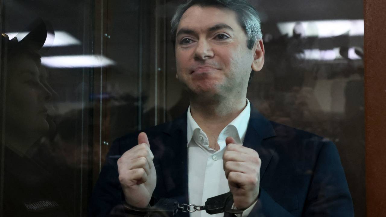 Grigory Melkonyants, the co-chair of independent Russian election monitoring group Golos, accused of cooperation with an "undesirable" organisation, reacts inside the glass defendants' box during the verdict announcement at the Basmanny district court in Moscow on May 14, 2025. (Photo by STRINGER / AFP)
