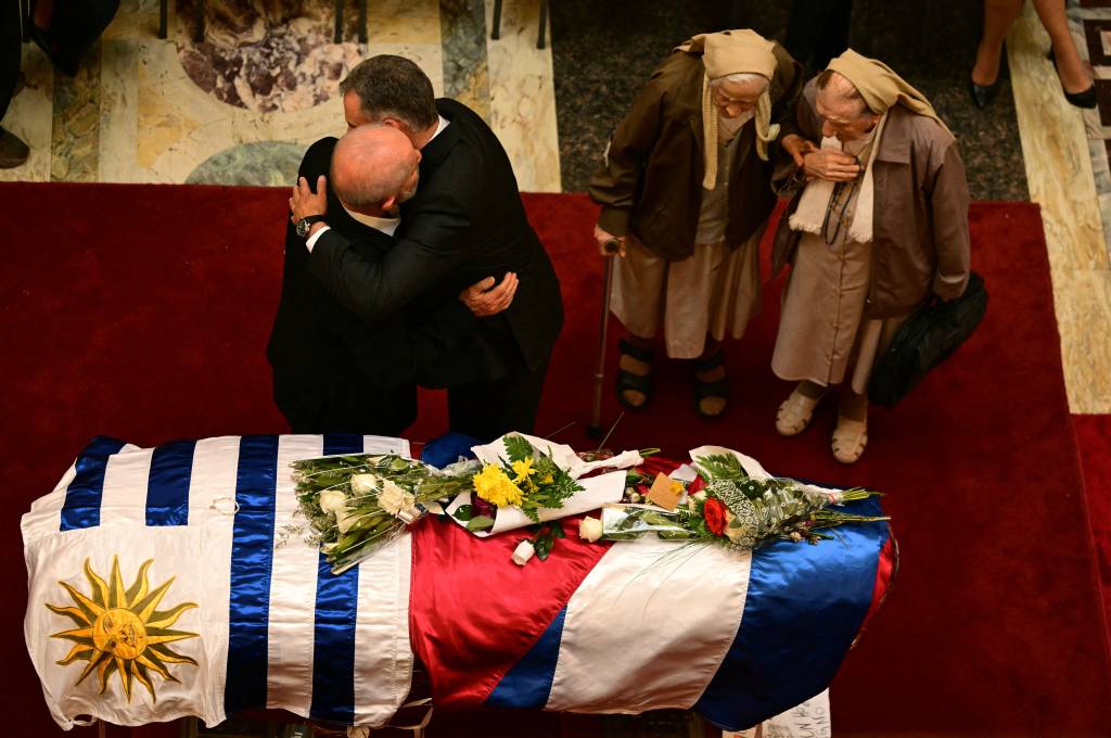 URUGUAY-POLITICS-MUJICA-DEATH-FUNERAL Brazil's President Luiz Inacio Lula da Silva (L) hugs Uruguay's President Yamandu Orsi next to two nuns paying last respects to Uruguay's former President Jose 'Pepe' Mujica, at the Palacio Legislativo in Montevideo, on May 15, 2025. From the eve, thousands of Uruguayans lined the streets to bid farewell to deceased former leader Jose