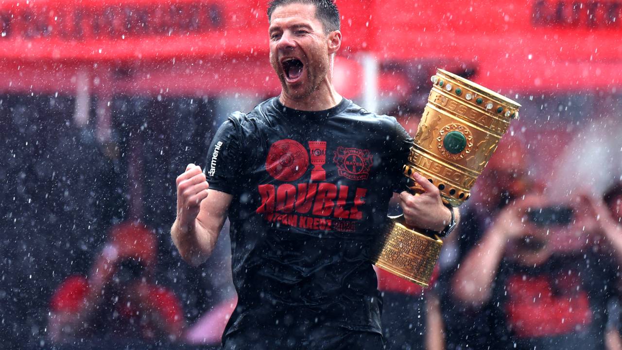 LEVERKUSEN, GERMANY - MAY 26: Xabi Alonso, Head Coach of Bayer 04 Leverkusen, celebrates with the DFB-Pokal trophy during the Bayer 04 Leverkusen champions party at BayArena on May 26, 2024 in Leverkusen, Germany.