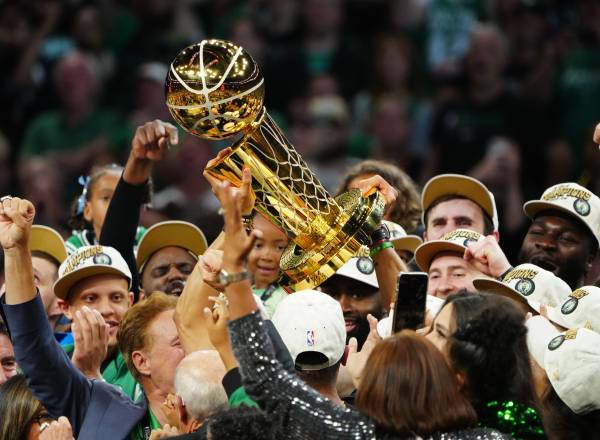 BOSTON, MA - JUNE 17: The Boston Celtics lift up the Larry O'Brien trophy after winning the 2024 NBA Championship against the Dallas Mavericks during Game 5 of the 2024 NBA Finals on June 17, 2024 at the TD Garden in Boston, Massachusetts. NOTE TO USER: User expressly acknowledges and agrees that, by downloading and or using this photograph, User is consenting to the terms and conditions of the Getty Images License Agreement. Mandatory Copyright Notice: Copyright 2024 NBAE