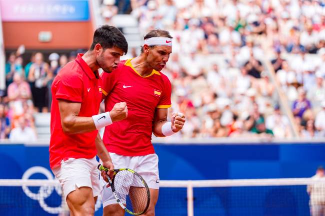 PARIS, FRANCE - JULY 30: Carlos Alcaraz of Team Spain celebrates with partner Rafael Nadal of Team Spain against Tallon Griekspoor of Team Netherlands and Wesley Koolhof of Team Netherlands during the Men's Doubles second round match on day four of the Olympic Games Paris 2024 at Roland Garros on July 30, 2024 in Paris, France (Photo by Andy Cheung/Getty Images)