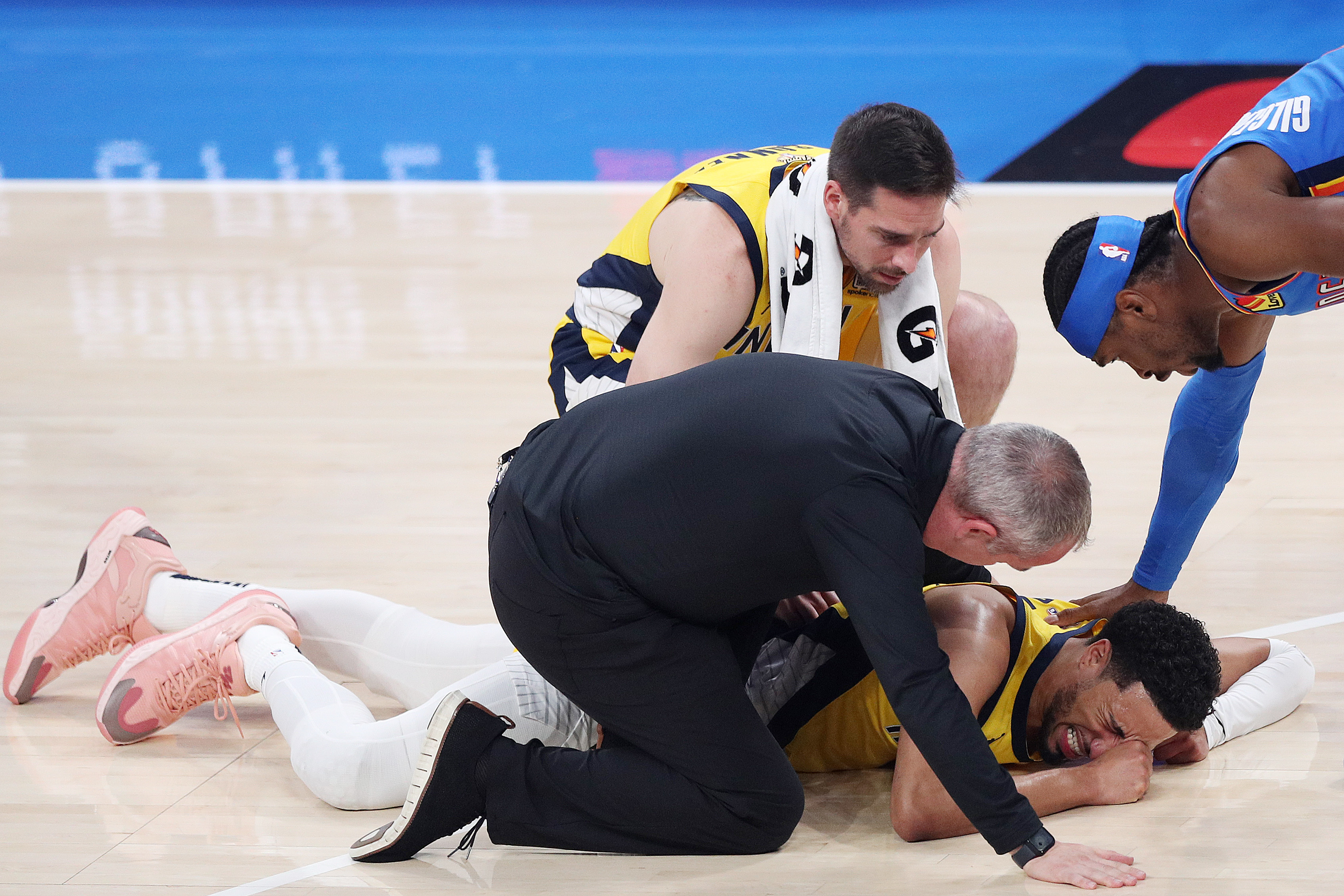 OKLAHOMA CITY, OKLAHOMA - JUNE 22: Tyrese Haliburton #0 of the Indiana Pacers sustains an injury during the first quarter as Shai Gilgeous-Alexander #2 of the Oklahoma City Thunder checks on him in Game Seven of the 2025 NBA Finals at Paycom Center on June 22, 2025 in Oklahoma City, Oklahoma. NOTE TO USER: User expressly acknowledges and agrees that, by downloading and or using this photograph, User is consenting to the terms and conditions of the Getty Images License Agreement. (Photo by Justin Ford/Getty Images)