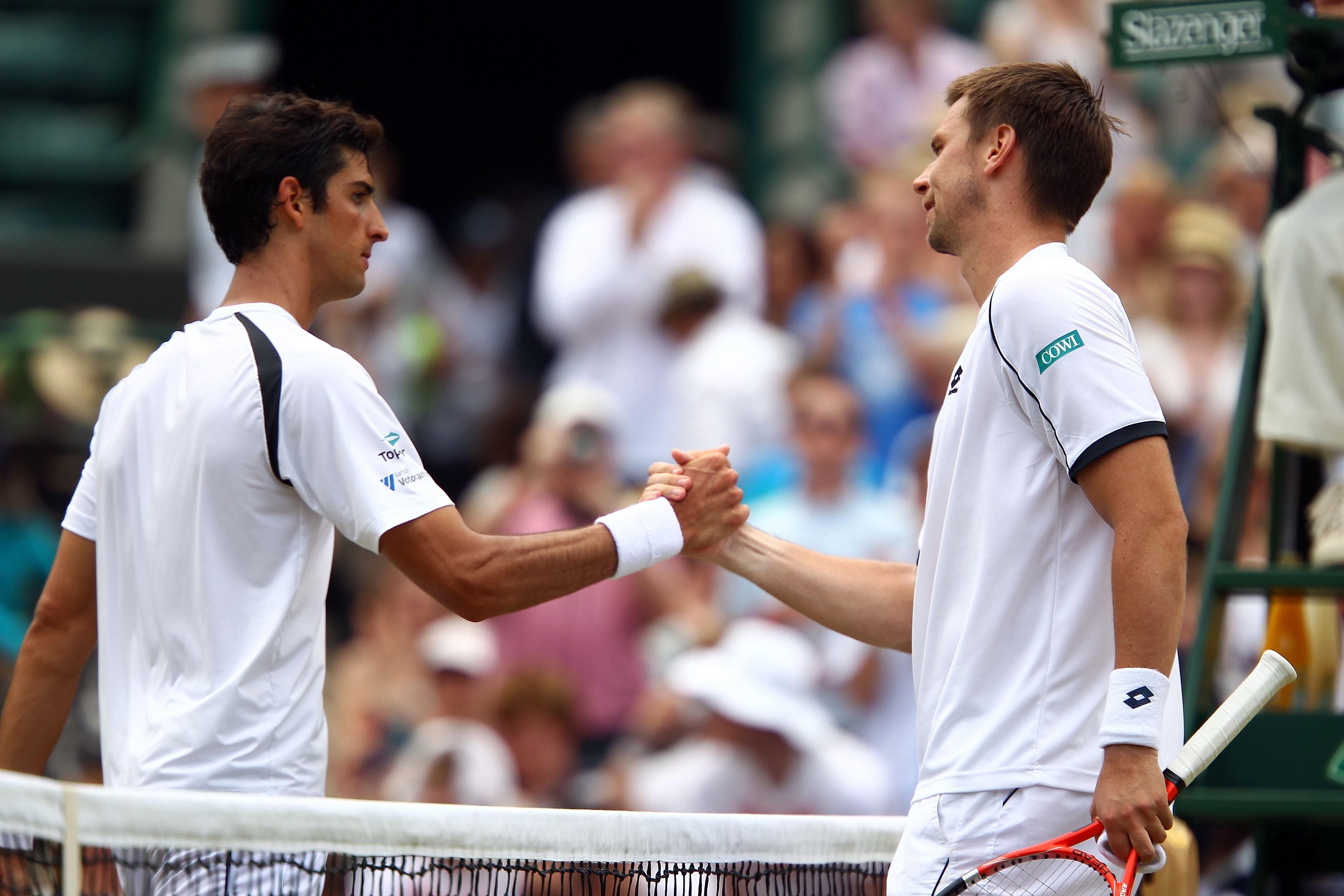 LONDON, ENGLAND - JUNE 26: Robin Soderling of Sweden (R) shakes hands after winning his match against Thomaz Bellucci of Brazil on Day Six of the Wimbledon Lawn Tennis Championships at the All England Lawn Tennis and Croquet Club on June 26, 2010 in London, England. (Photo by Clive Brunskill/Getty Images)