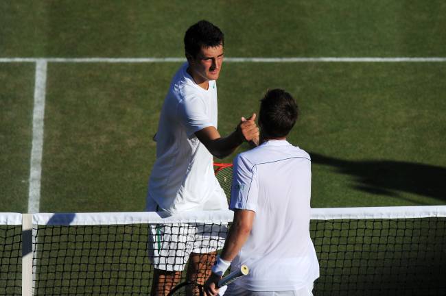 LONDON, ENGLAND - JUNE 25: Bernard Tomic of Australia (L) shakes hands with Robin Soderling of Sweden after winning his third round match on Day Six of the Wimbledon Lawn Tennis Championships at the All England Lawn Tennis and Croquet Club on June 25, 2011 in London, England. (Photo by Michael Regan/Getty Images)