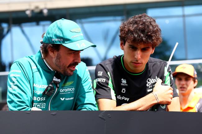 BUDAPEST, HUNGARY - AUGUST 03: Fernando Alonso of Spain and Aston Martin F1 Team and Gabriel Bortoleto of Brazil and Stake F1 Team Kick Sauber talk on the drivers parade prior to the F1 Grand Prix of Hungary at Hungaroring on August 03, 2025 in Budapest, Hungary. (Photo by Joe Portlock/Getty Images)