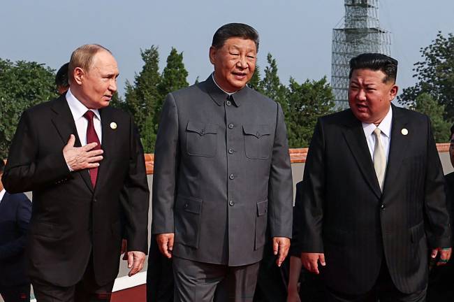 In this pool photograph distributed by the Russian state agency Sputnik, (L-R) Russia's President Vladimir Putin walks with China's President Xi Jinping and North Korea's leader Kim Jong Un before a military parade marking the 80th anniversary of victory over Japan and the end of World War II, in Beijing’s Tiananmen Square on September 3, 2025. (Photo by Alexander KAZAKOV / POOL / AFP)