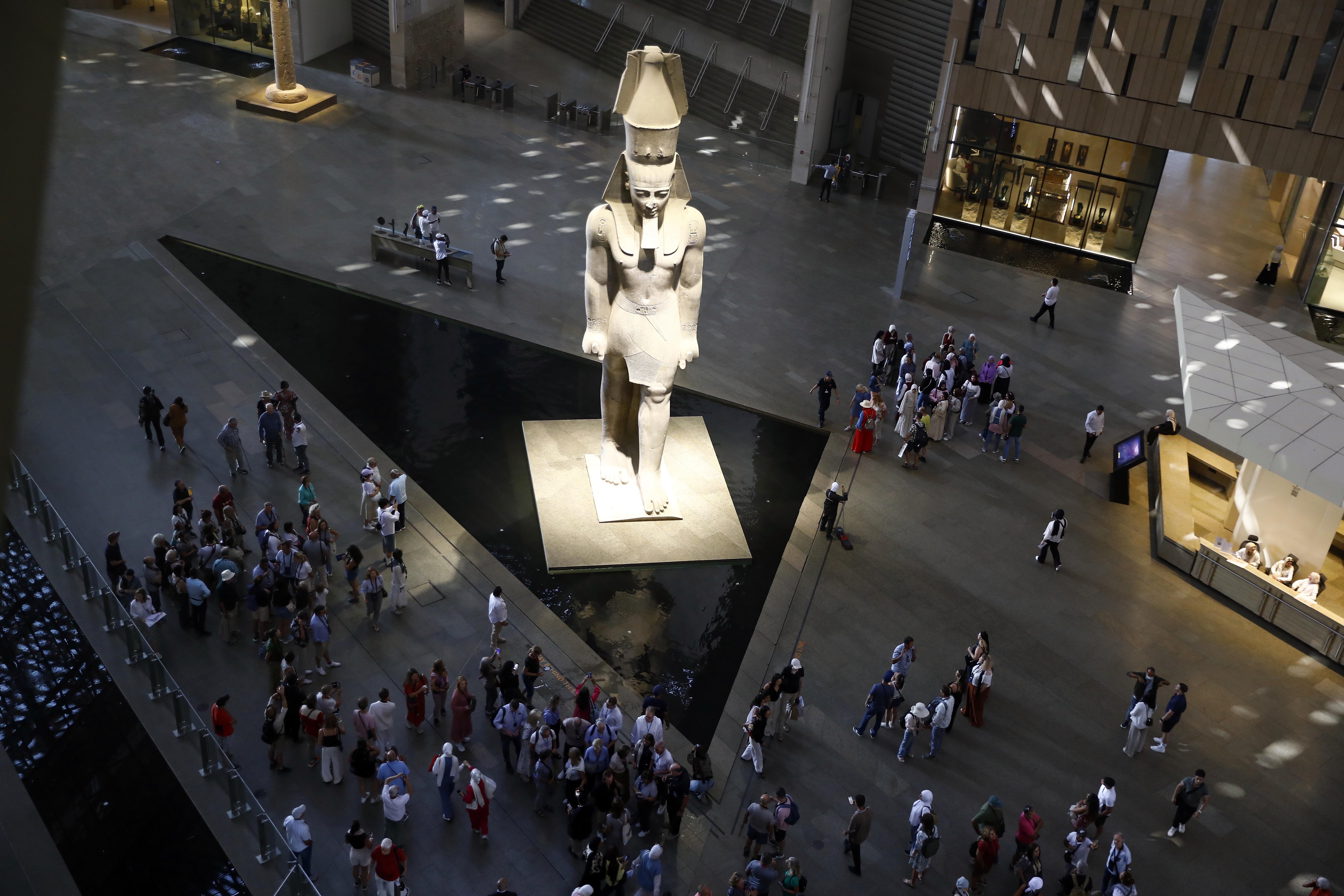 GIZA, EGYPT - OCTOBER 14: An aerial view of as tourists visit the Grand Egyptian Museum, located near the Pyramids of Giza, in Giza, Egypt, on October 14, 2025. The museum displays thousands of artifacts from prehistoric, Pharaonic, and Roman eras, including the golden treasures of King Tutankhamun, whose tomb was discovered in 1922. The site attracts thousands of visitors each year with its twelve exhibition halls, gardens, and cultural spaces. (Photo by Fareed Kotb/Anadolu via Getty Images)