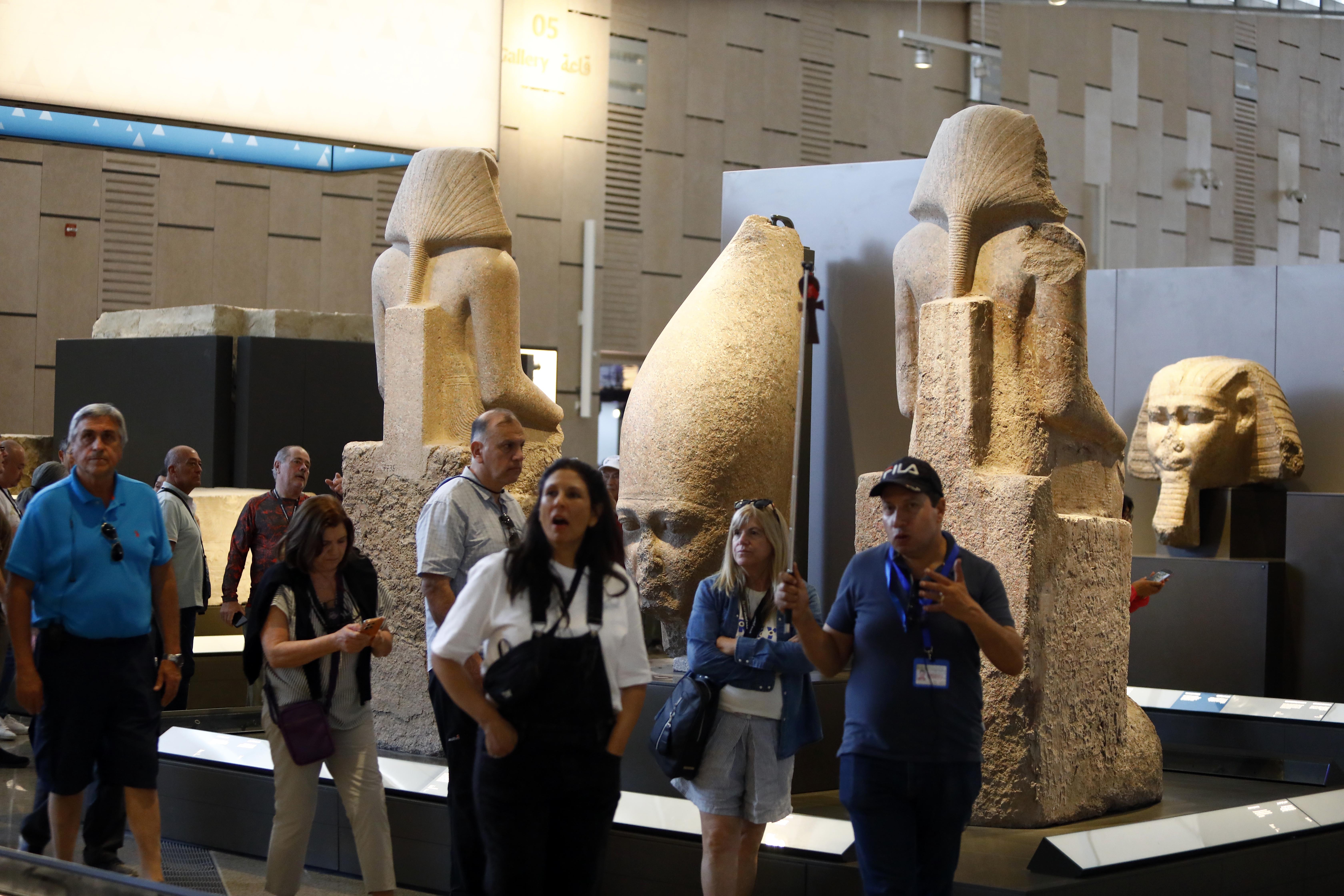 GIZA, EGYPT - OCTOBER 14: Tourists visit the Grand Egyptian Museum, located near the Pyramids of Giza, in Giza, Egypt, on October 14, 2025. The museum displays thousands of artifacts from prehistoric, Pharaonic, and Roman eras, including the golden treasures of King Tutankhamun, whose tomb was discovered in 1922. The site attracts thousands of visitors each year with its twelve exhibition halls, gardens, and cultural spaces. (Photo by Fareed Kotb/Anadolu via Getty Images)