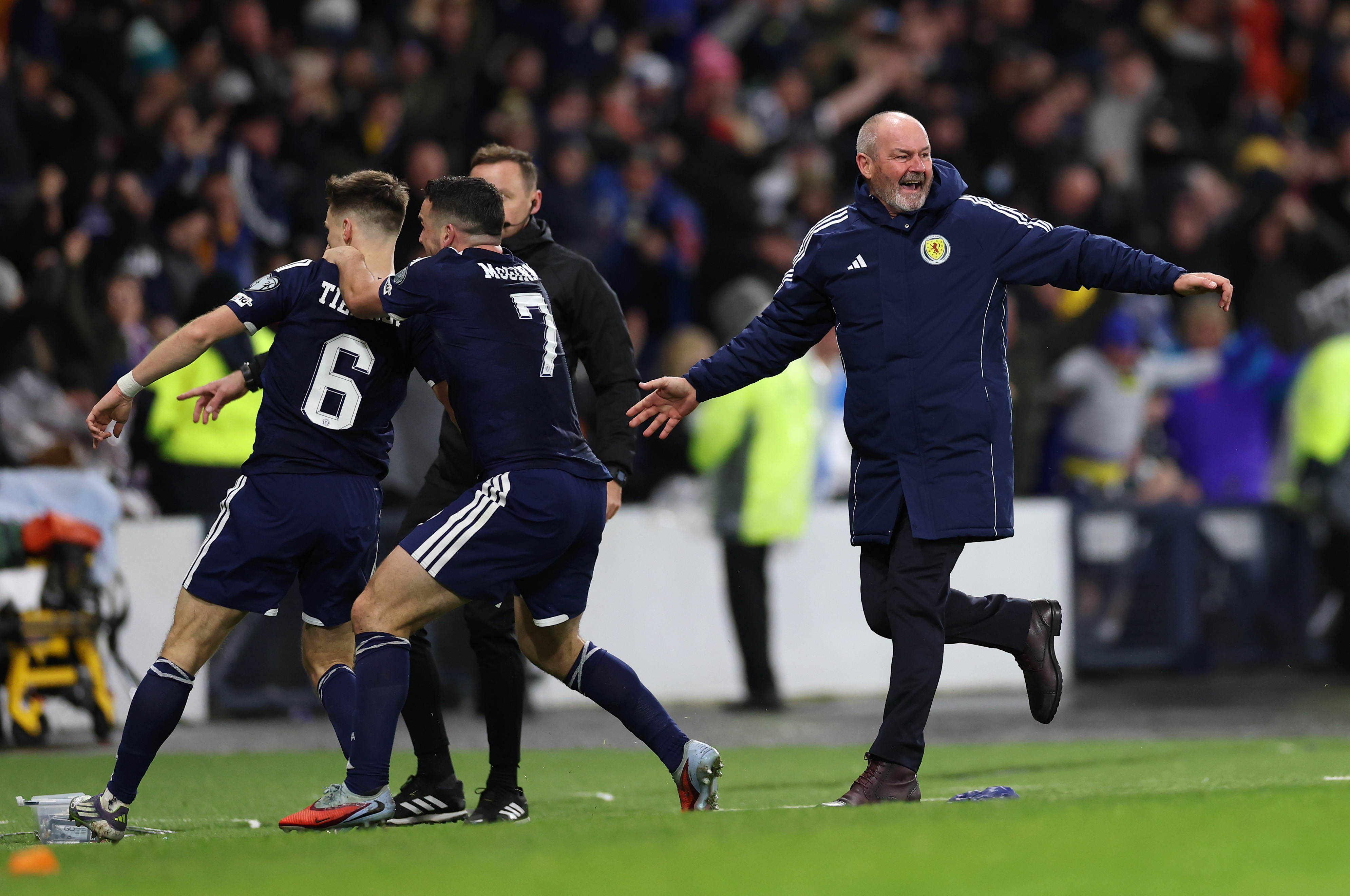 GLASGOW, SCOTLAND - NOVEMBER 18: Kieran Tierney of Scotland celebrates scoring his team's third goal with Steve Clarke, Head Coach of Scotland, and teammates during the FIFA World Cup 2026 qualifier match between Scotland and Denmark at Hampden Park on November 18, 2025 in Glasgow, Scotland. (Photo by Stu Forster/Getty Images)