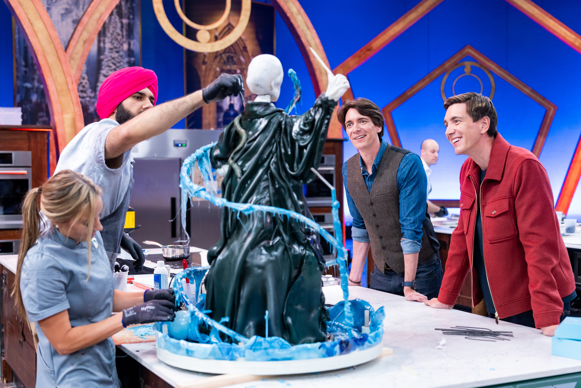 hosts-james-and-oliver-phelps-with-competitors-katie-bonzer-and-jujhar-mann-on-food-network-s-harry-potter-wizards-of-baking-season-2