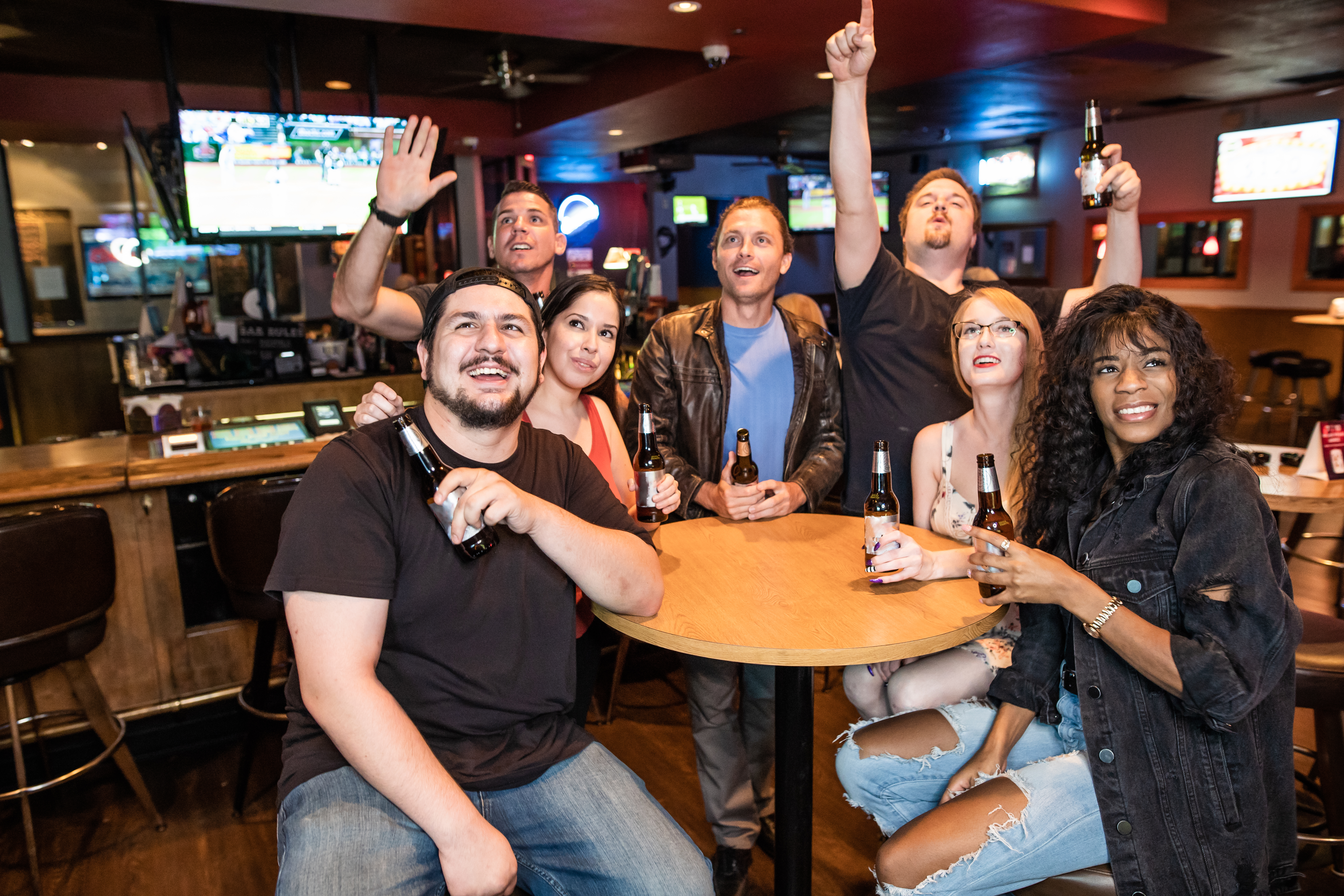 Friends in the bar watching sports and drinking beer