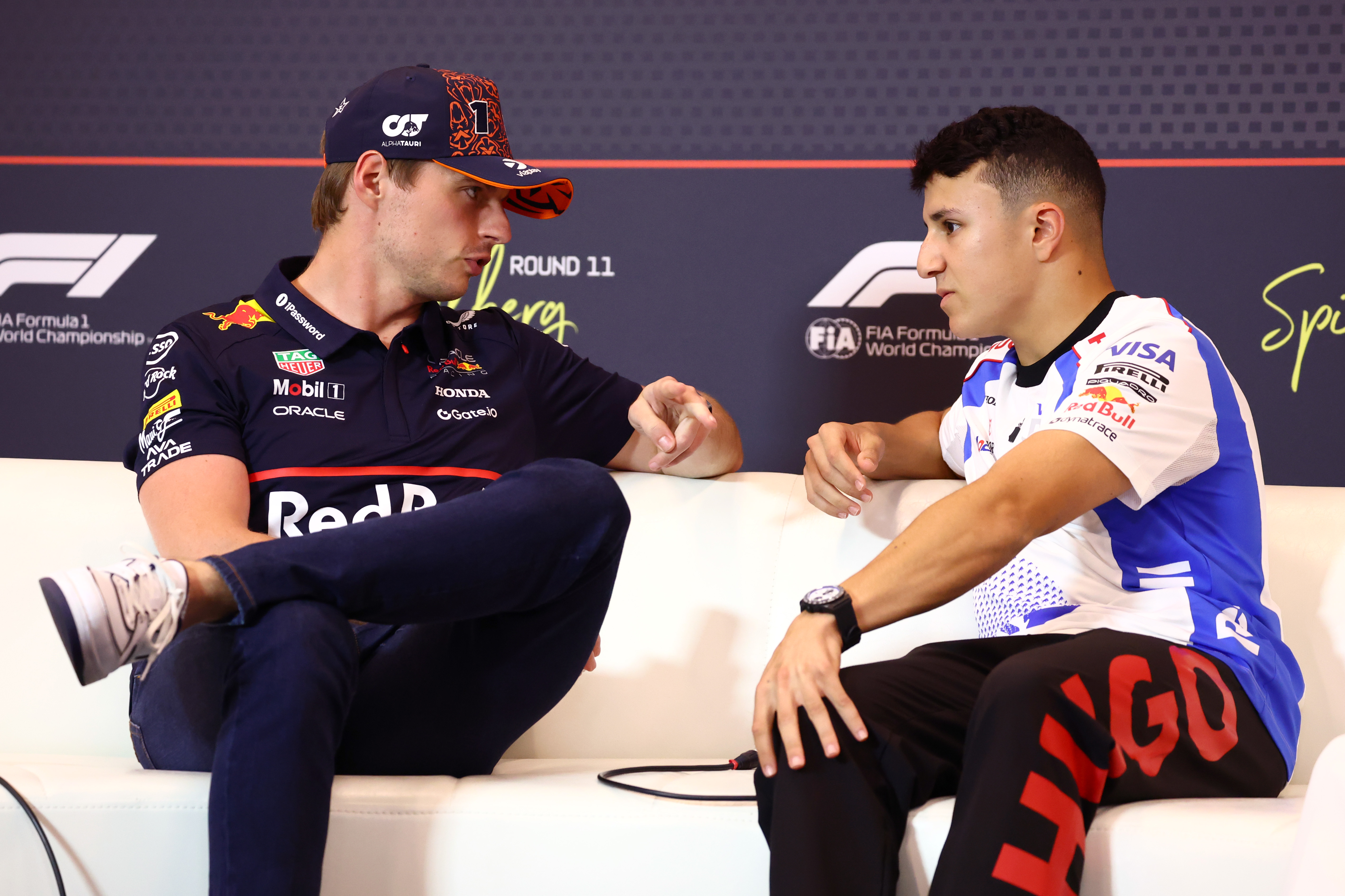 SPIELBERG, AUSTRIA - JUNE 26: Max Verstappen of the Netherlands and Oracle Red Bull Racing and Isack Hadjar of France and Visa Cash App Racing Bulls talk in the Drivers Press Conference during previews ahead of the F1 Grand Prix of Austria at Red Bull Ring on June 26, 2025 in Spielberg, Austria. (Photo by Clive Rose/Getty Images)