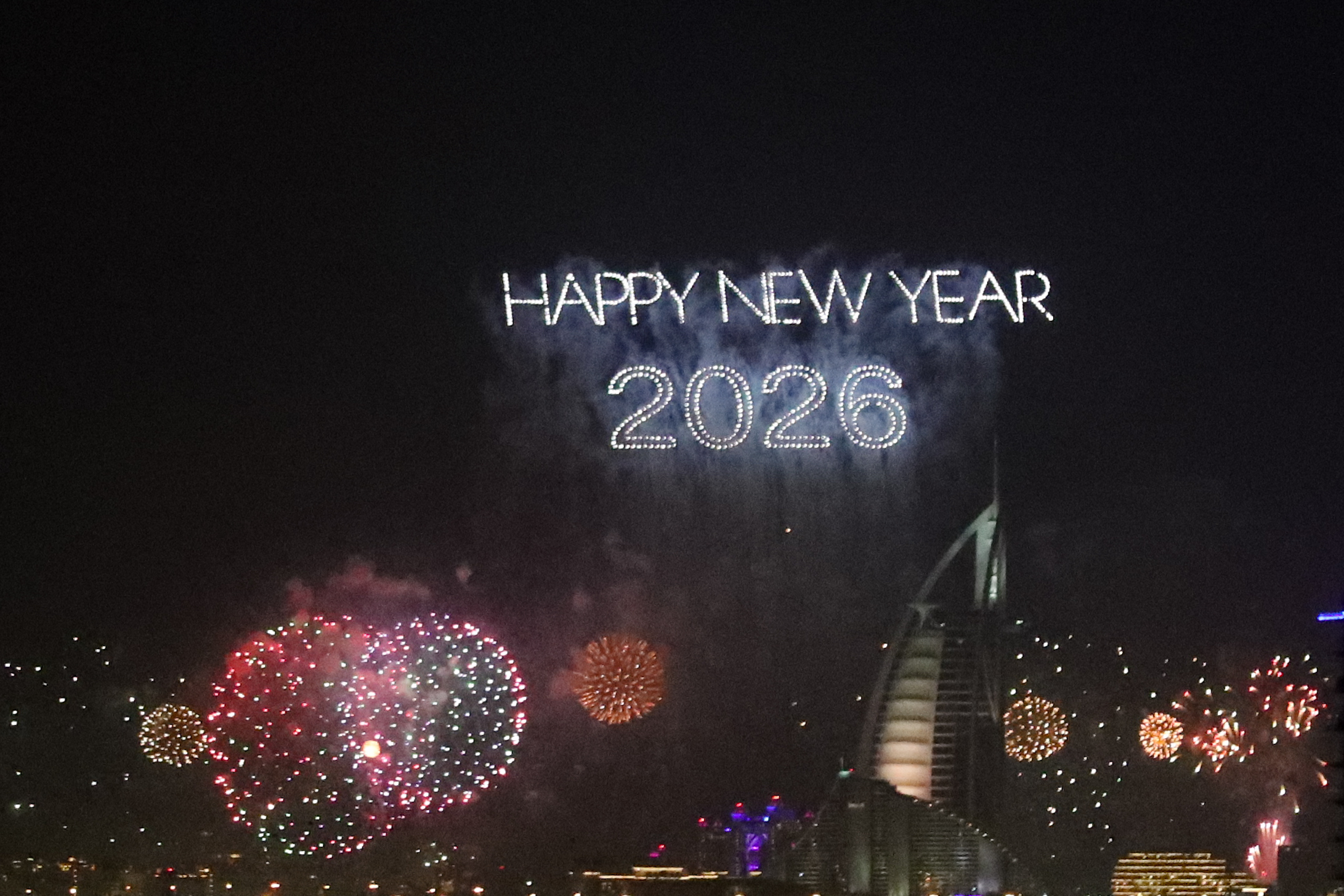 DUBAI, UAE - DECEMBER 31: New year is welcomed with fireworks and light shows held at Burj al Arab in Dubai, United Arab Emirates on December 31, 2025. (Photo by Waleed Zein/Anadolu via Getty Images)