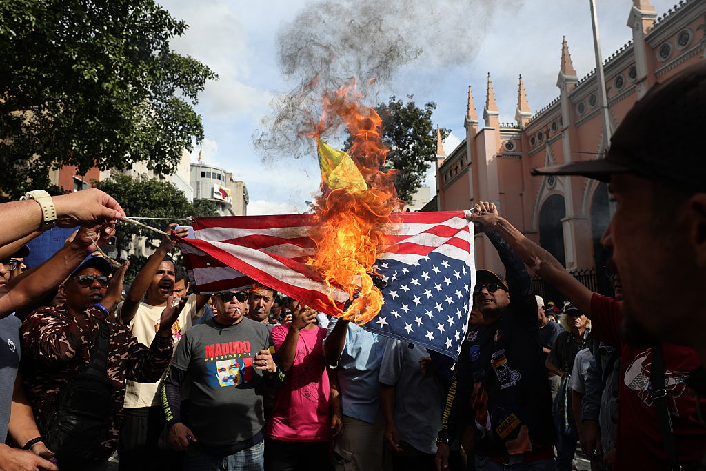 03 January 2026, Venezuela, Caracas: Venezuelans burn a US flag after the announcement of the US attacks and the capture of Venezuelan leader Maduro. Photo: Stringer/dpa (Photo by Stringer/picture alliance via Getty Images)