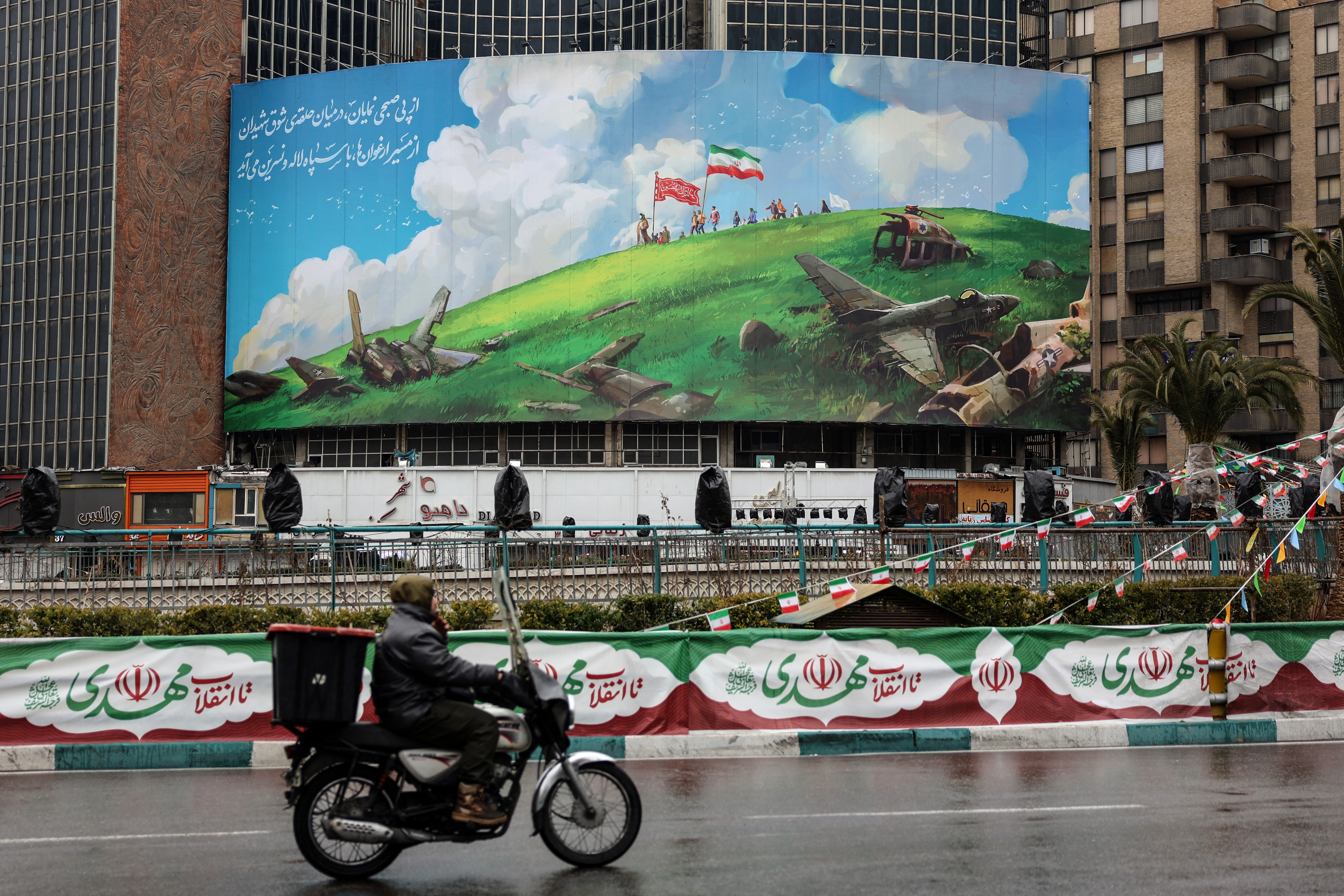 A photograph shows an anti-US billboard displayed on a building in Tehran's Valiasr Square on February 4, 2026. (Photo by AFP)