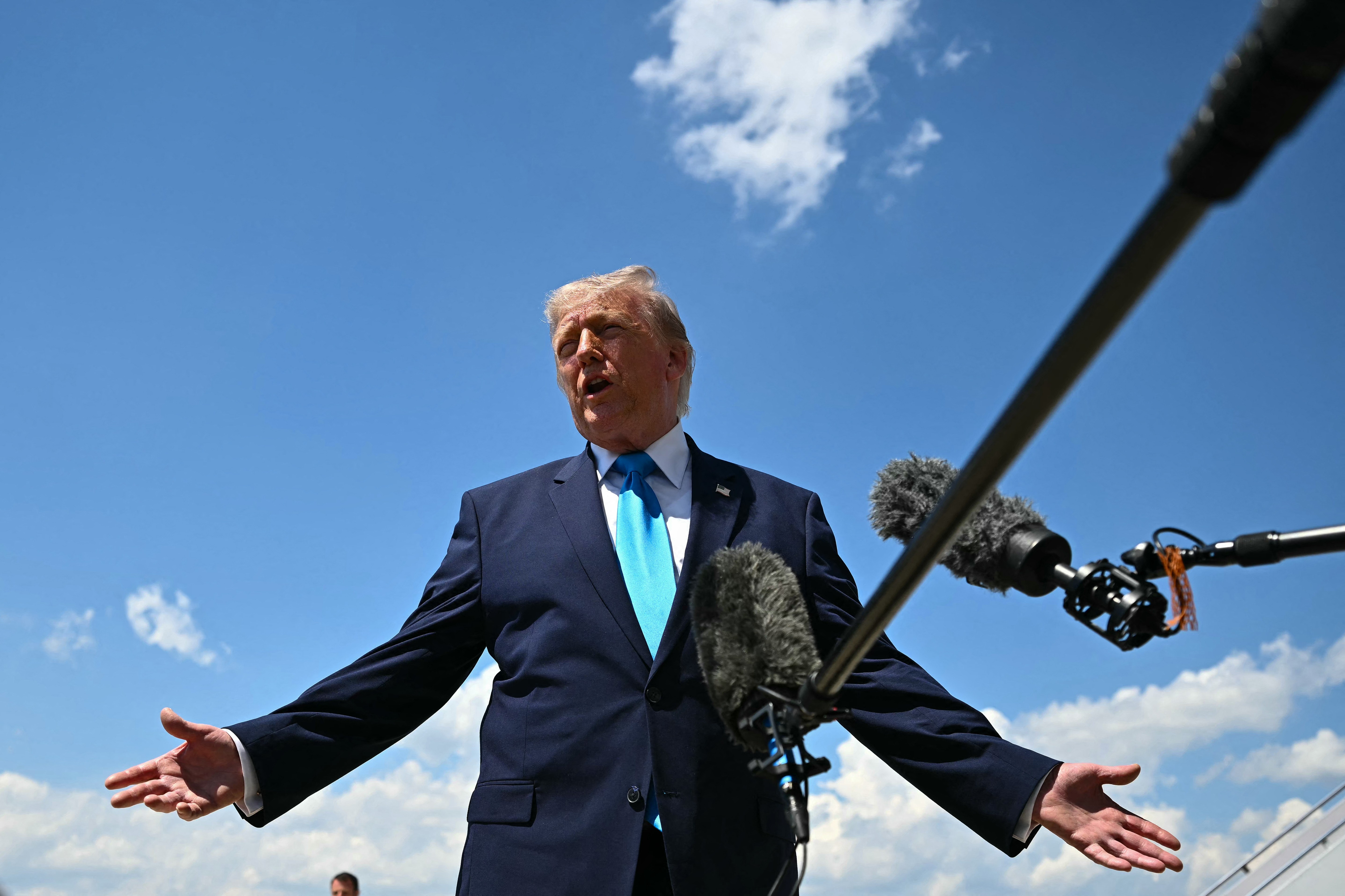 US President Donald Trump speaks to reporters after stepping off Air Force One at Joint Base Andrews, Maryland on May 20, 2026, as he returns to Washington, DC, after delivering the commmencement address to the US Coast Guard Academy's 2026 graduating class.
