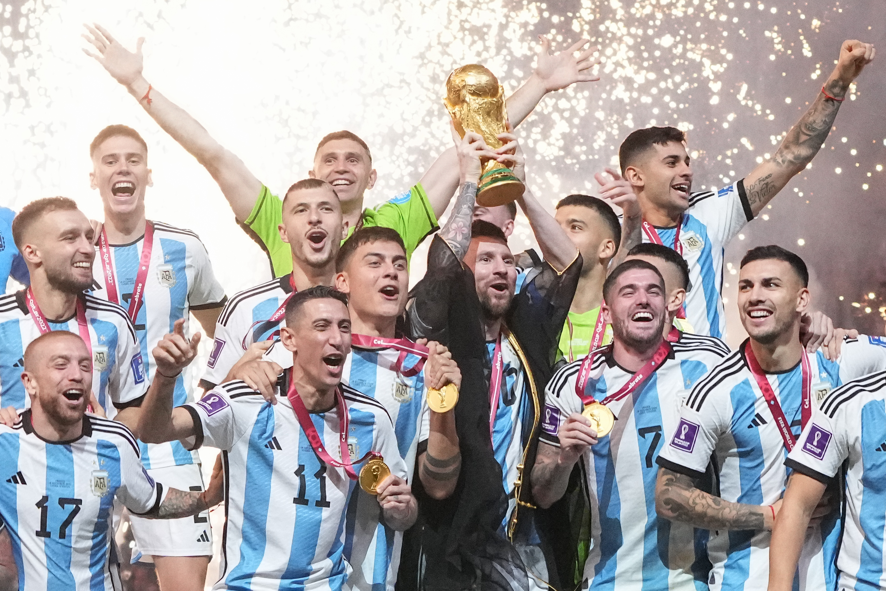 LUSAIL CITY, QATAR - DECEMBER 18: Lionel Messi of Argentina lifts the FIFA World Cup Trophy as he celebrates with team mates at the award ceremony following the FIFA World Cup Qatar 2022 Final match between Argentina and France at Lusail Stadium on December 18, 2022 in Lusail City, Qatar. (Photo by Cui Nan/China News Service/VCG via Getty Images)