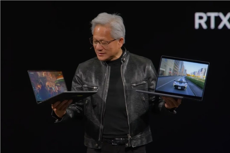 Homem asiático de cabelos grisalhos, óculos e jaqueta de couro preta, segurando dois notebooks abertos. Na tela esquerda, uma imagem de paisagem; na direita, um carro em uma rua urbana. Ao fundo, a palavra "RTX" em branco sobre preto